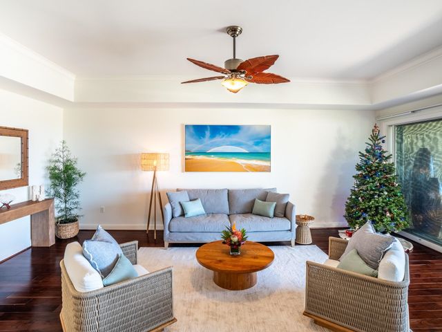 a living room with furniture and a potted plant