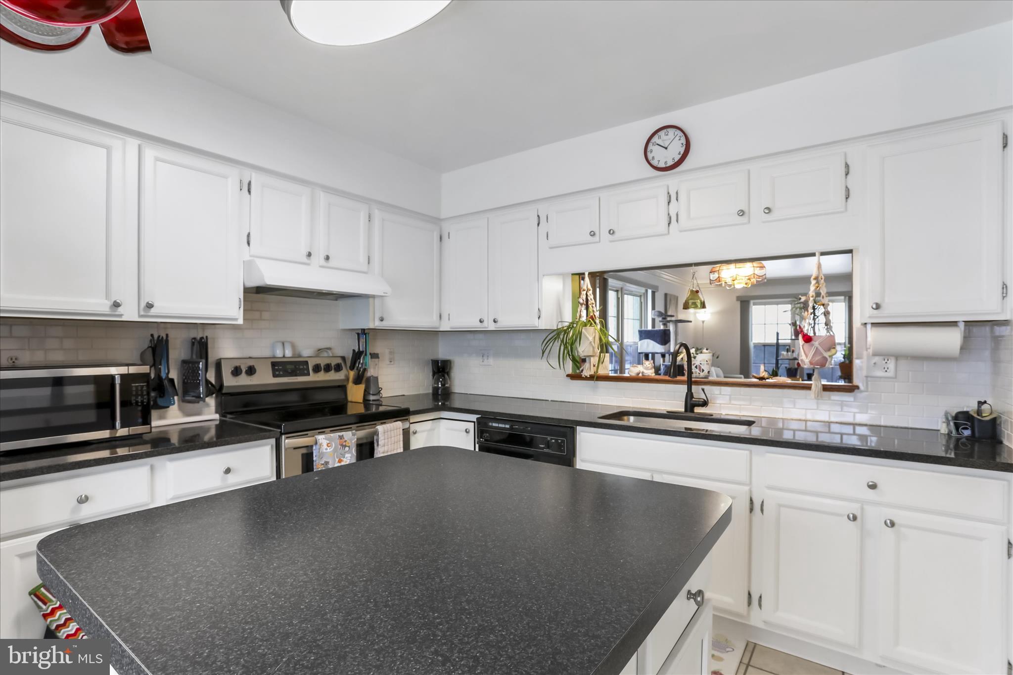 60 Morningside Drive Falling Waters, WV 25419 - Photo 7 of 45 a kitchen with stainless steel appliances granite countertop a sink a stove and cabinets