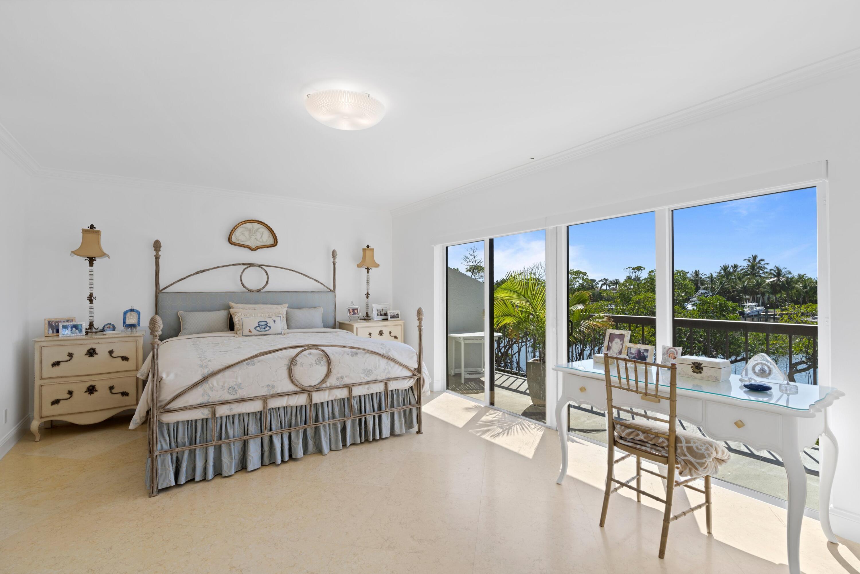 3474 South Ocean Boulevard, Unit 14 Palm Beach, FL 33480 - Photo 18 of 64 a bedroom with a bed and a large window with balcony view
