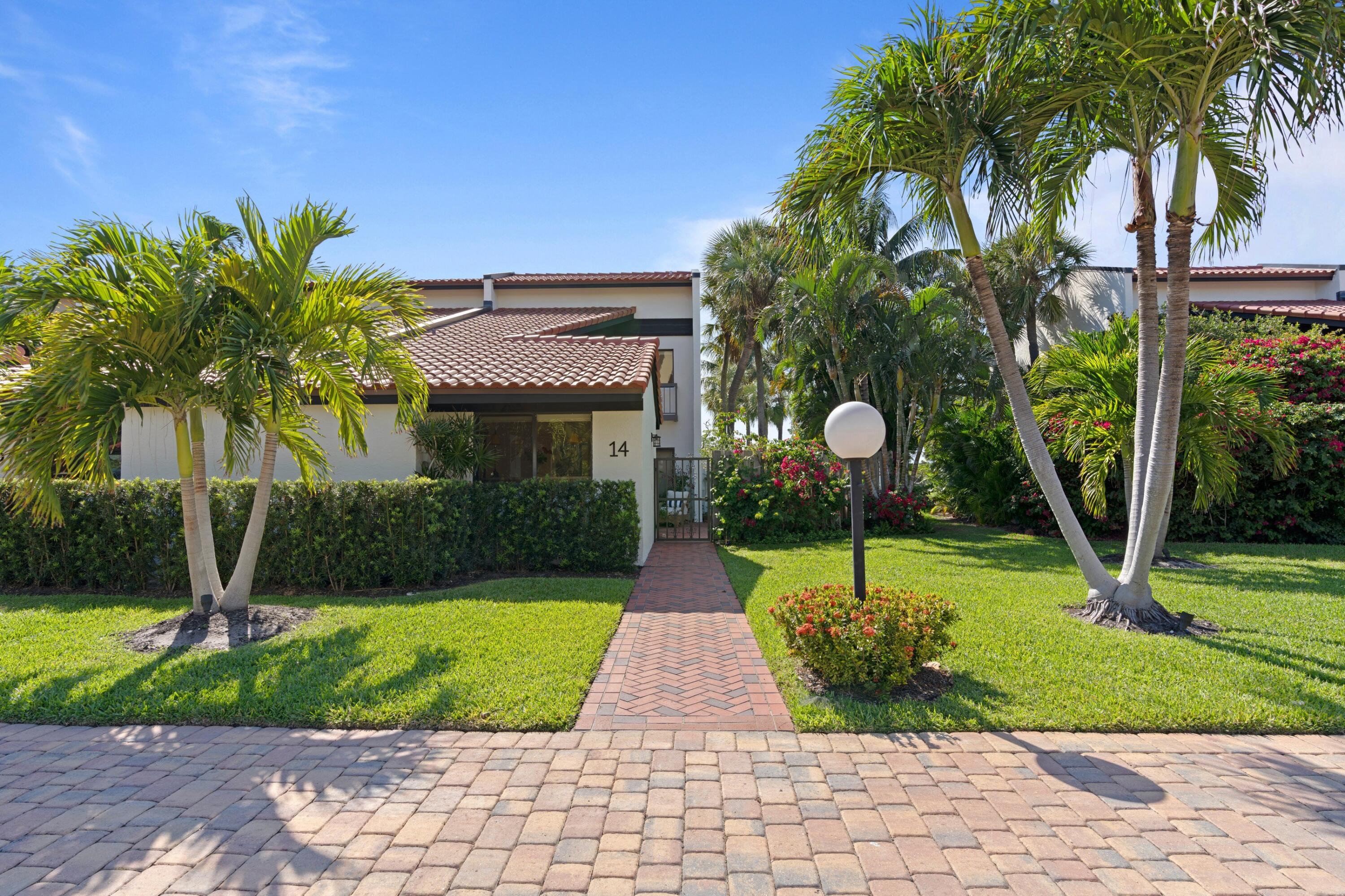 3474 South Ocean Boulevard, Unit 14 Palm Beach, FL 33480 - Photo 47 of 64 a front view of a house with garden