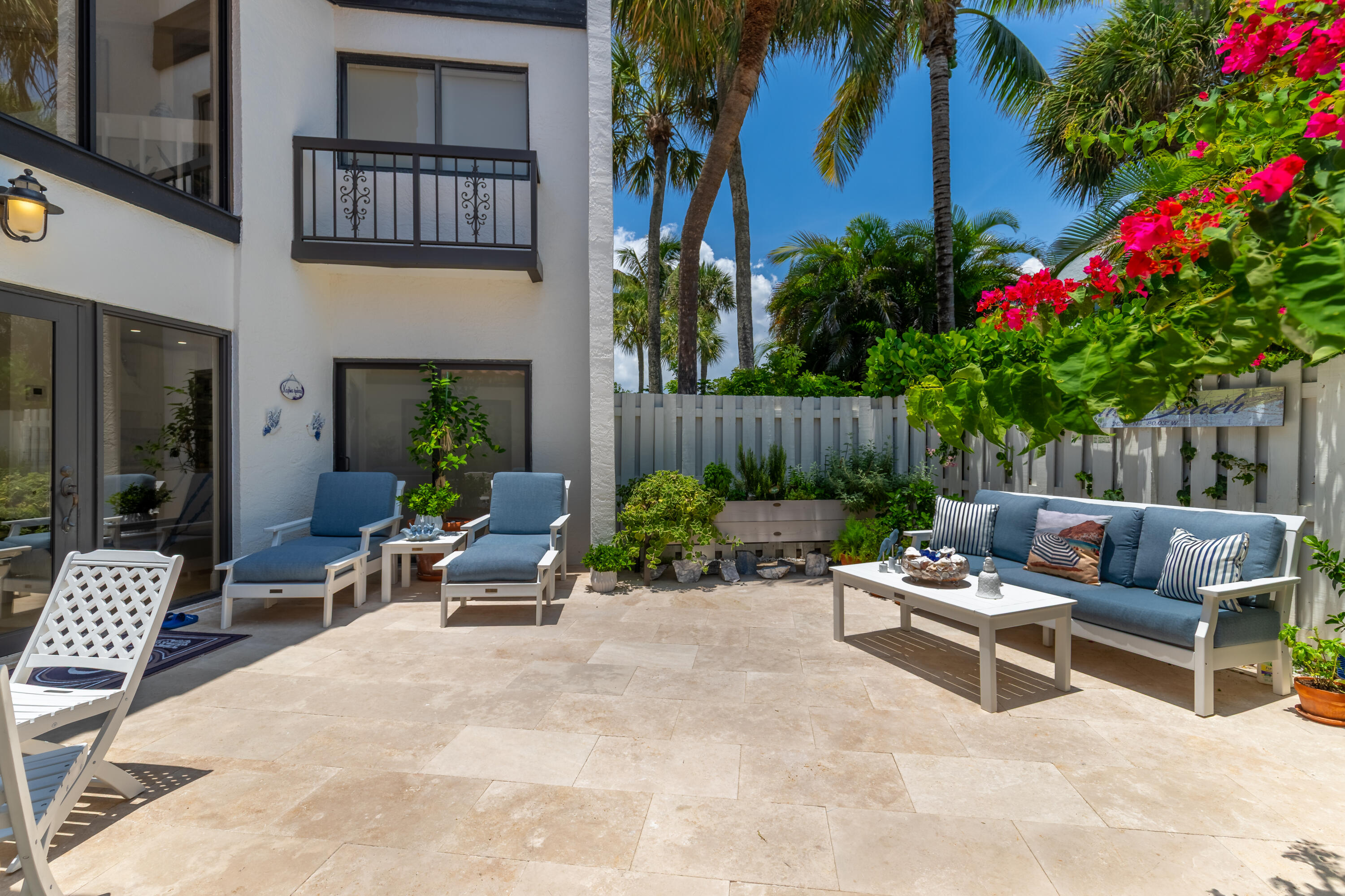 3474 South Ocean Boulevard, Unit 14 Palm Beach, FL 33480 - Photo 52 of 64 a view of a patio with couches and a table and chairs