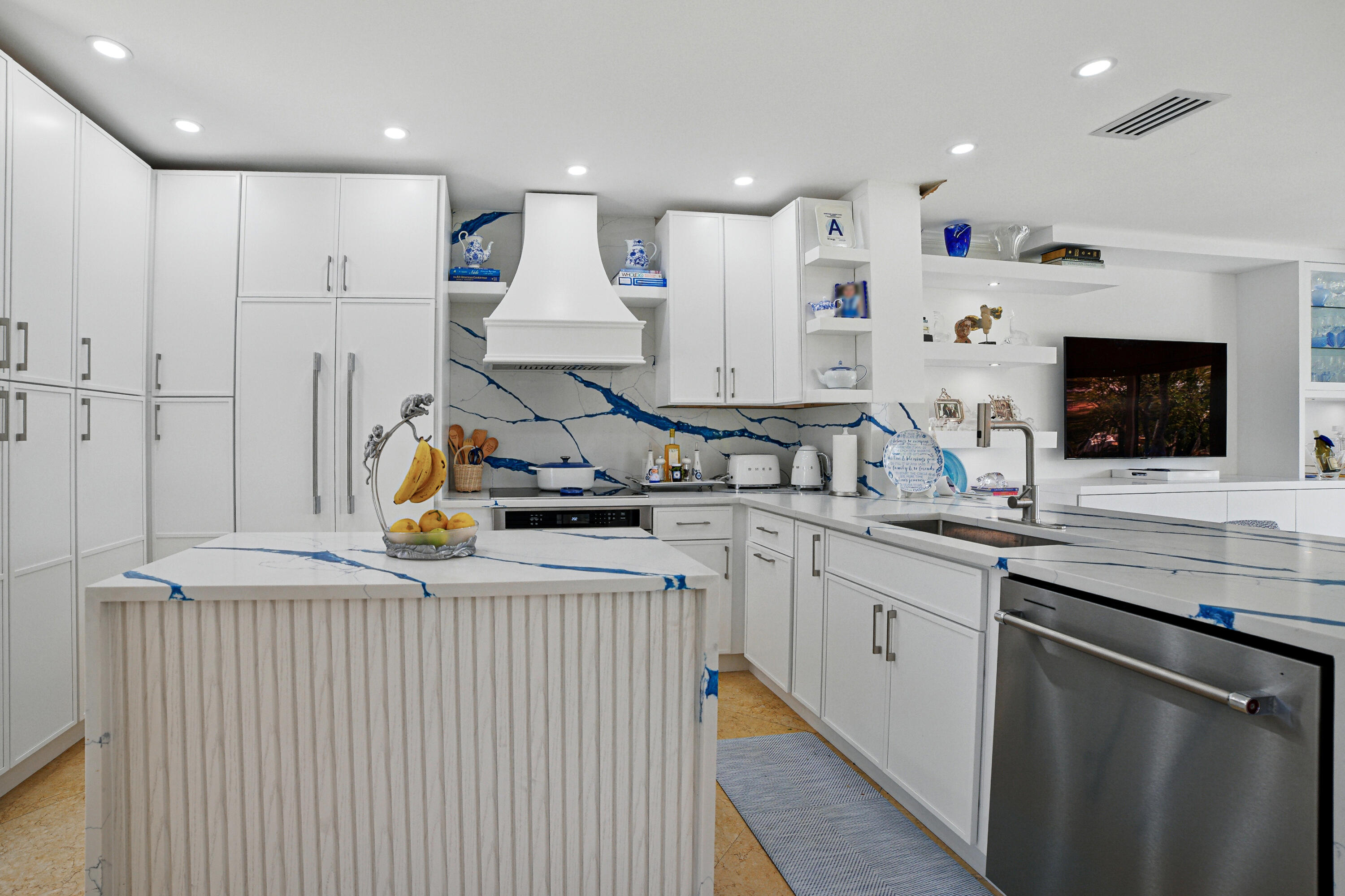 3474 South Ocean Boulevard, Unit 14 Palm Beach, FL 33480 - Photo 8 of 64 a kitchen with stainless steel appliances granite countertop a sink and a stove top oven with wooden floor