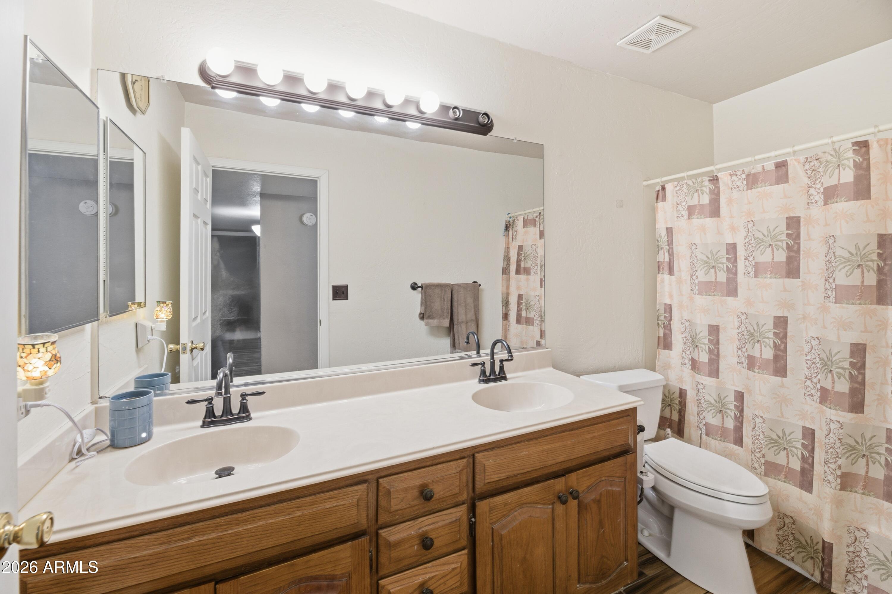 30 East Palo Verde Street Gilbert, AZ 85296 - Photo 17 of 38 a bathroom with a double vanity sink mirror double and toilet