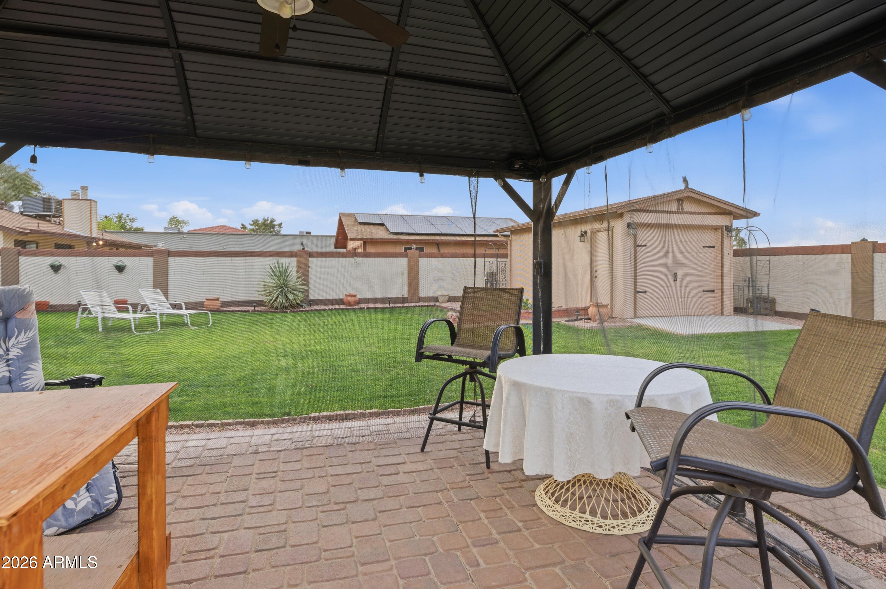 30 East Palo Verde Street Gilbert, AZ 85296 - Photo 26 of 38 a backyard of a house with table and chairs