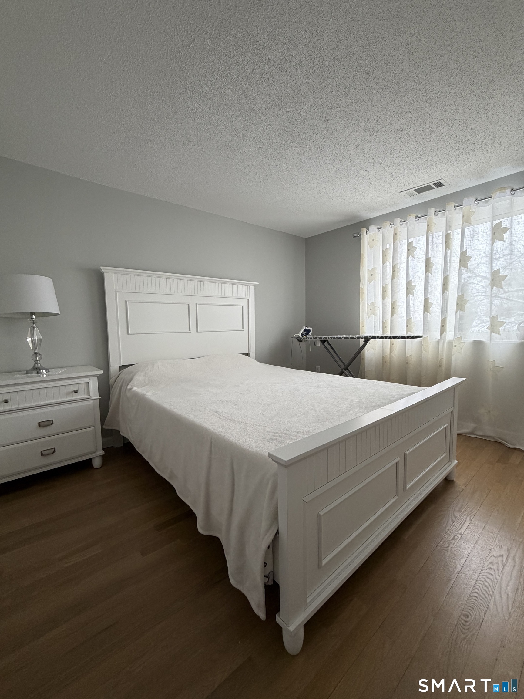 43 Sun Ridge Lane, Unit 43 Cromwell, CT 06416 - Photo 17 of 30 a bedroom with a bed and a night stand