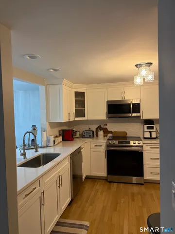 a kitchen with a refrigerator and a stove