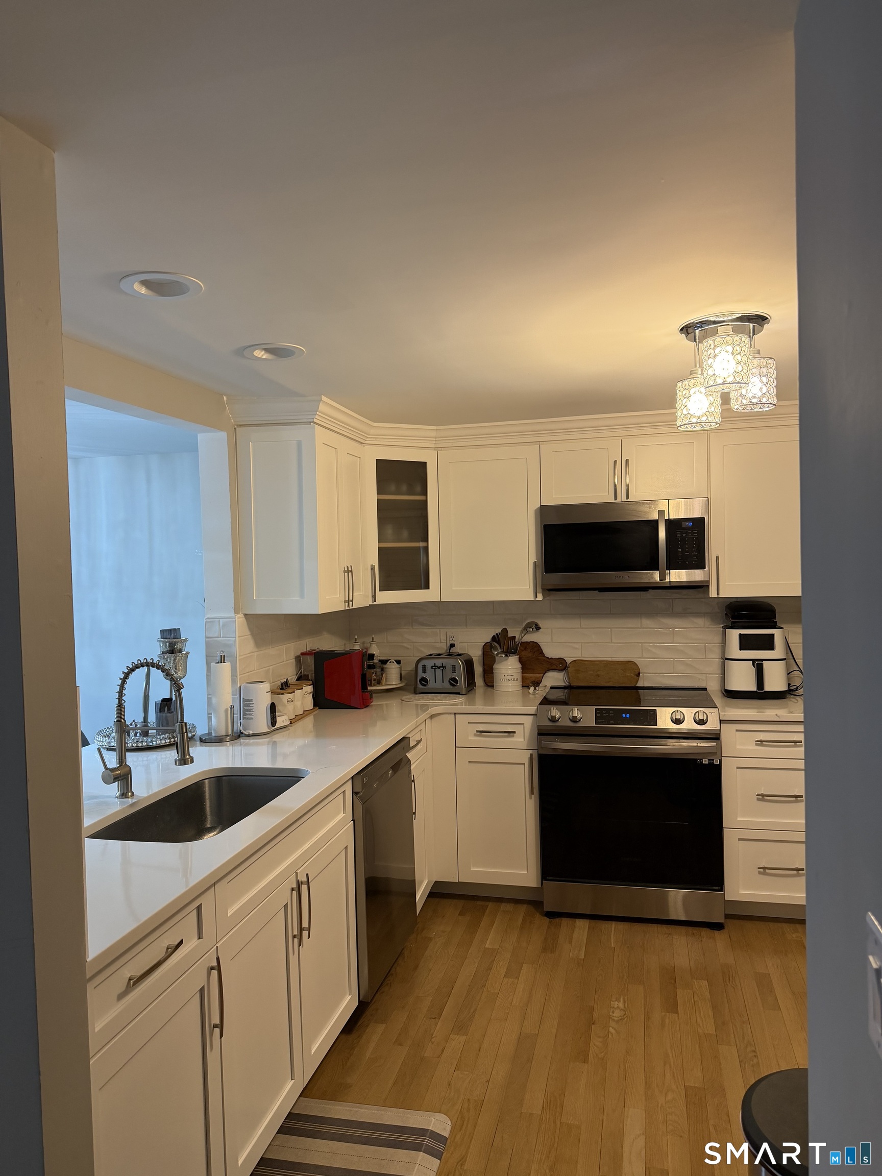 43 Sun Ridge Lane, Unit 43 Cromwell, CT 06416 - Photo 4 of 30 a kitchen with stainless steel appliances granite countertop a sink and stove top oven