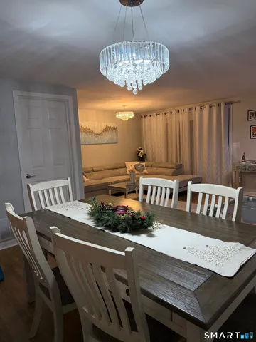 a dining room with furniture and wooden floor