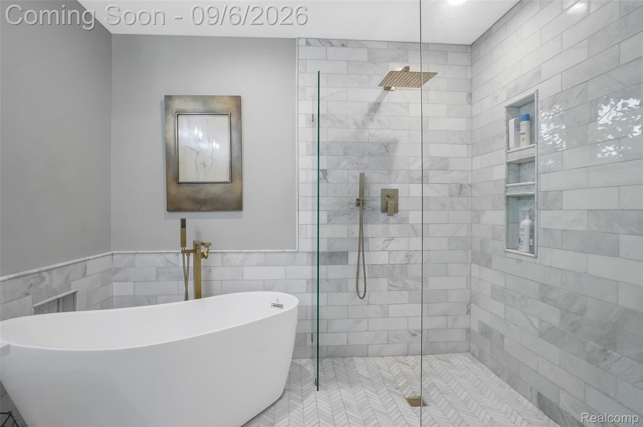 13203 Log Cabin Point Fenton, MI 48430 - Photo 24 of 55 Freestanding soaking tub with floor-mounted faucet, glass-enclosed shower with a rain shower head and handheld sprayer, and tiled walls and flooring