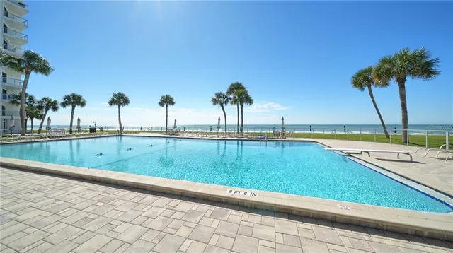 a front view of a building with street and sign board