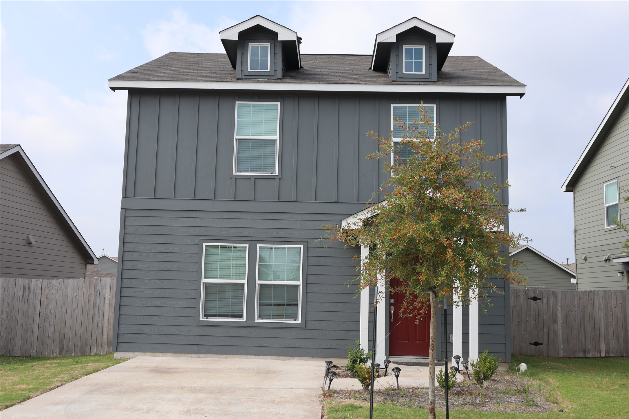 View of front of house featuring board and batten siding and a shingled roof