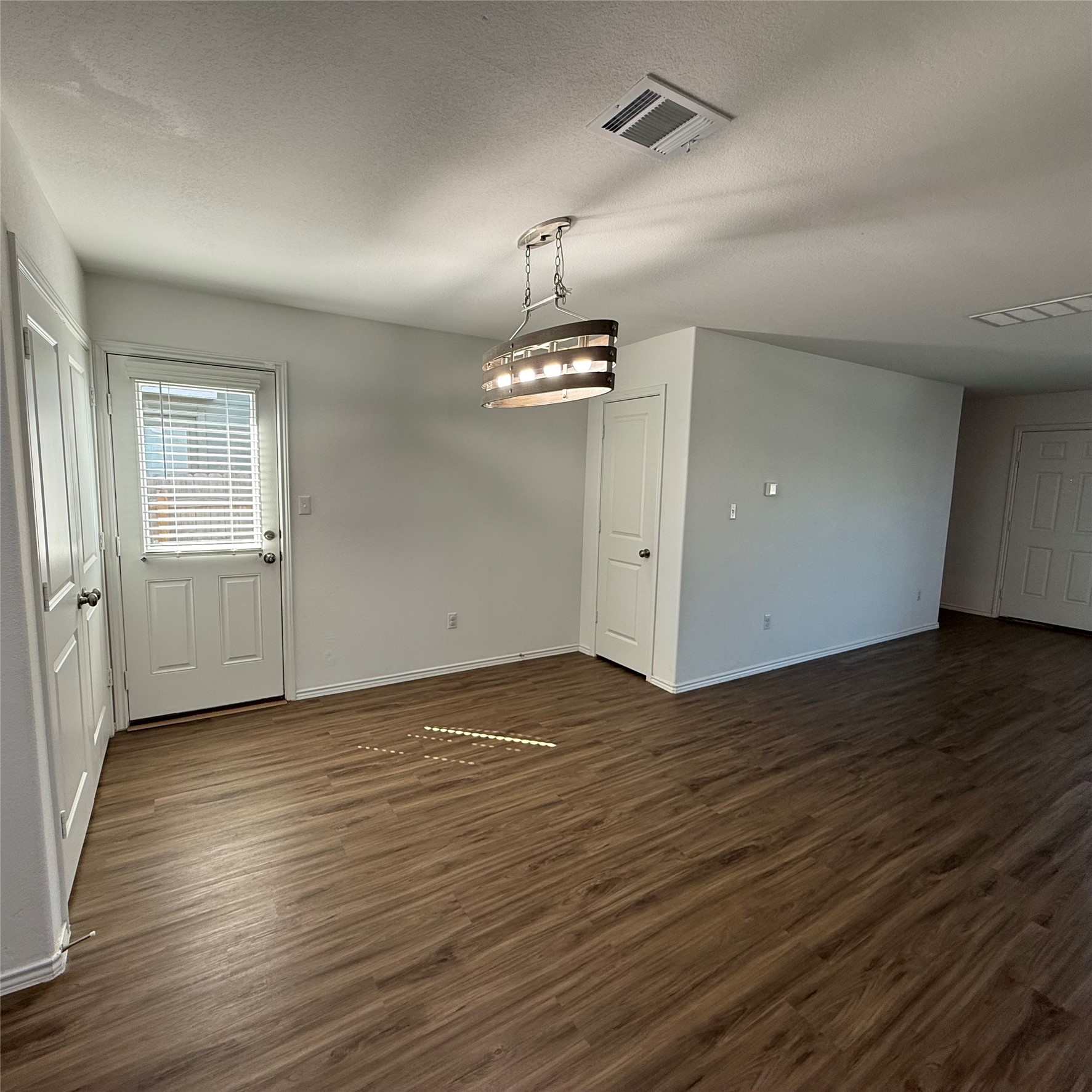 13711 Mussel Run Elgin, TX 78621 - Photo 11 of 31 Unfurnished dining area featuring dark wood-style floors and baseboards