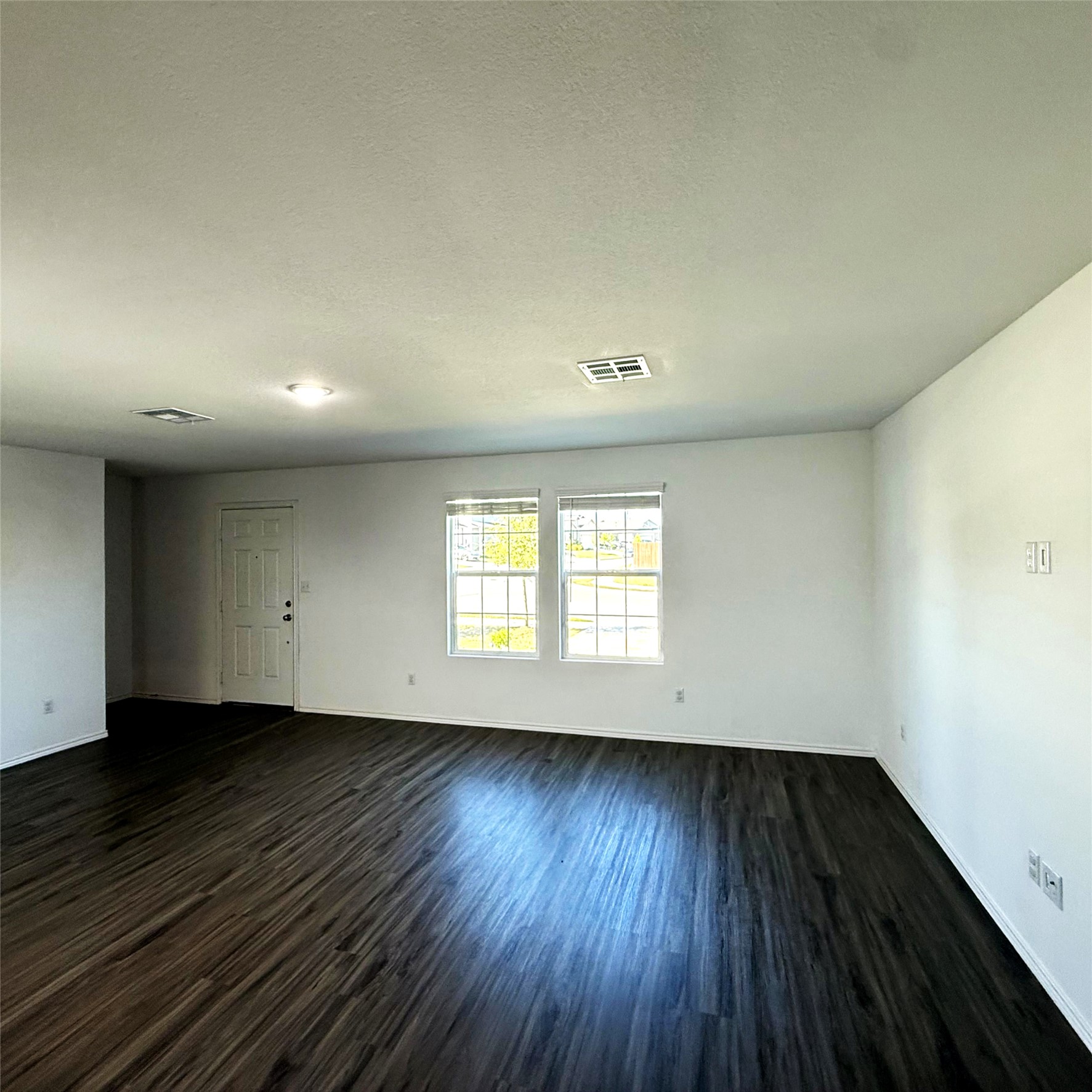 13711 Mussel Run Elgin, TX 78621 - Photo 19 of 31 Spare room with dark wood-type flooring and a textured ceiling
