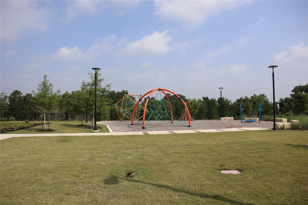 13711 Mussel Run Elgin, TX 78621 - Photo 20 of 31 Community play area with a lawn