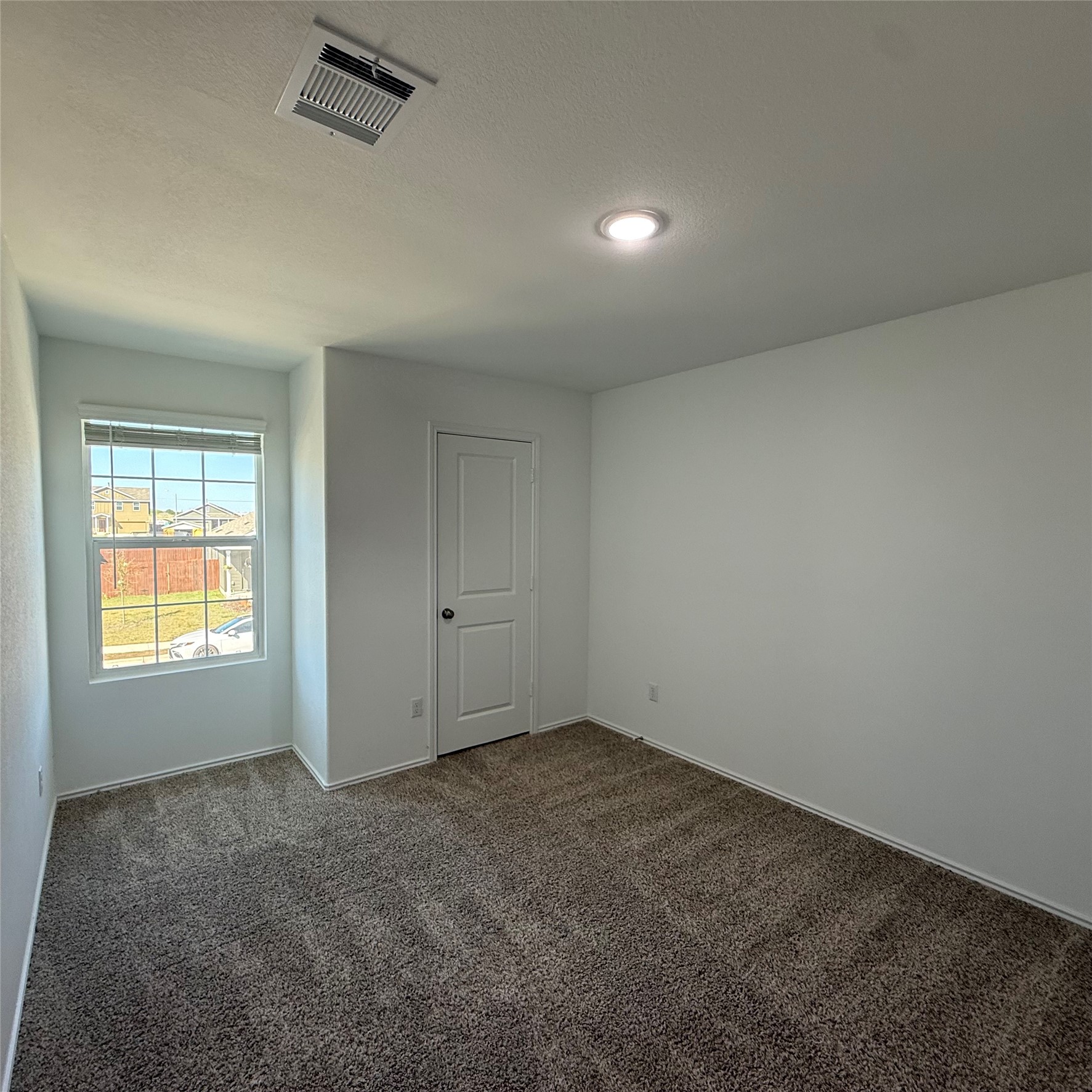 13711 Mussel Run Elgin, TX 78621 - Photo 25 of 31 Spare room with dark colored carpet and a textured ceiling