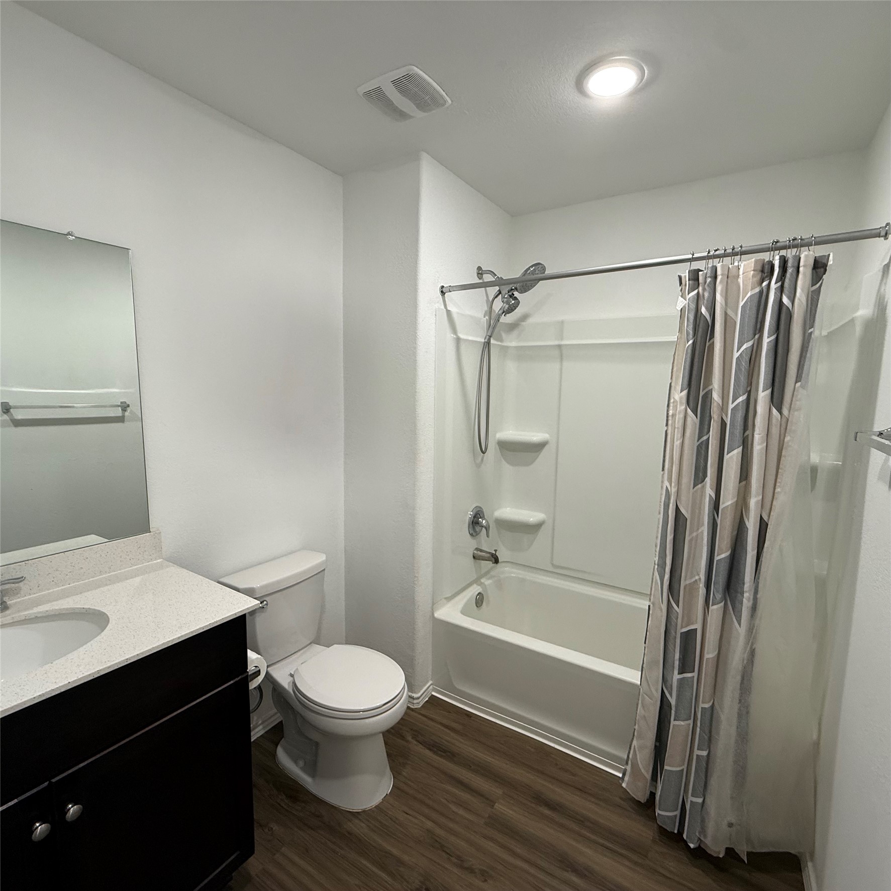 13711 Mussel Run Elgin, TX 78621 - Photo 7 of 31 Full bathroom with dark wood-style floors, vanity, and shower / bath combo with shower curtain