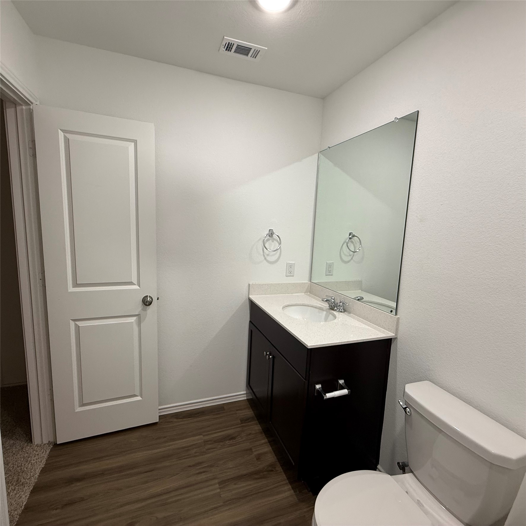 13711 Mussel Run Elgin, TX 78621 - Photo 9 of 31 Bathroom featuring vanity and dark wood-style flooring