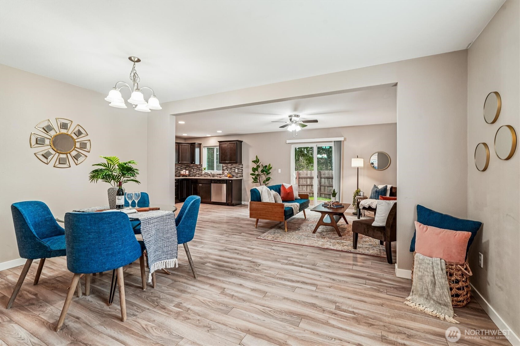 741 Northeast Larson Boulevard Belfair, WA 98528 - Photo 11 of 32 a living room with furniture dining table and a chandelier