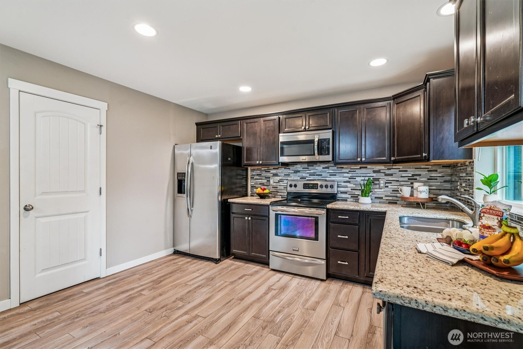 741 Northeast Larson Boulevard Belfair, WA 98528 - Photo 15 of 32 a kitchen with stainless steel appliances granite countertop a refrigerator stove and sink
