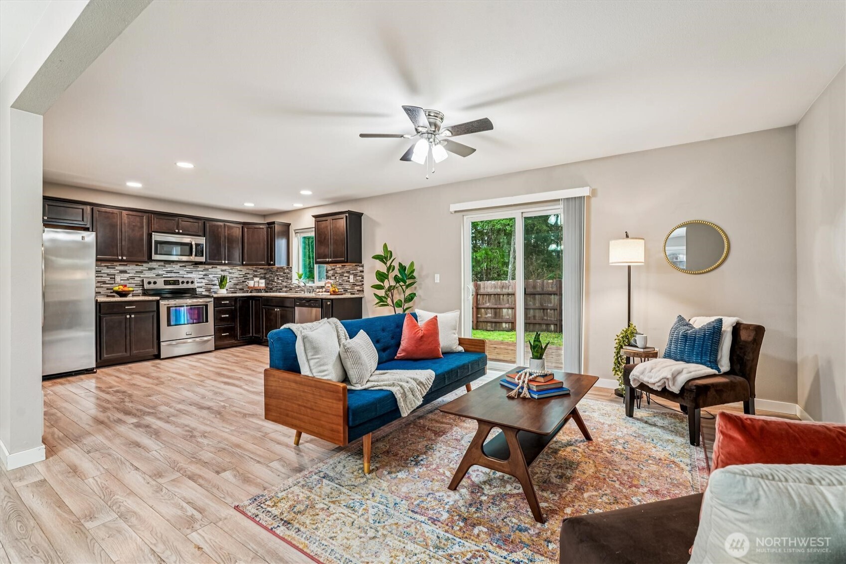 741 Northeast Larson Boulevard Belfair, WA 98528 - Photo 16 of 32 a living room with furniture kitchen view and a large window