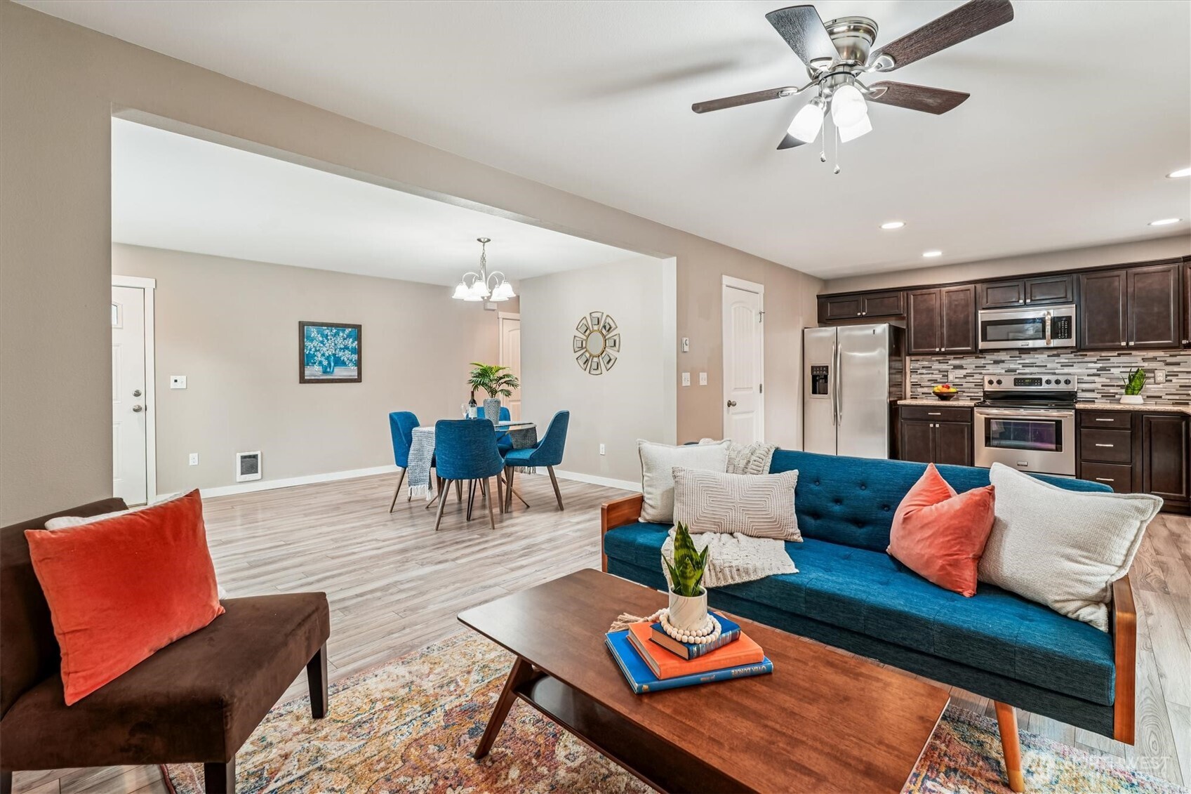 741 Northeast Larson Boulevard Belfair, WA 98528 - Photo 19 of 32 a living room with furniture kitchen view and a chandelier
