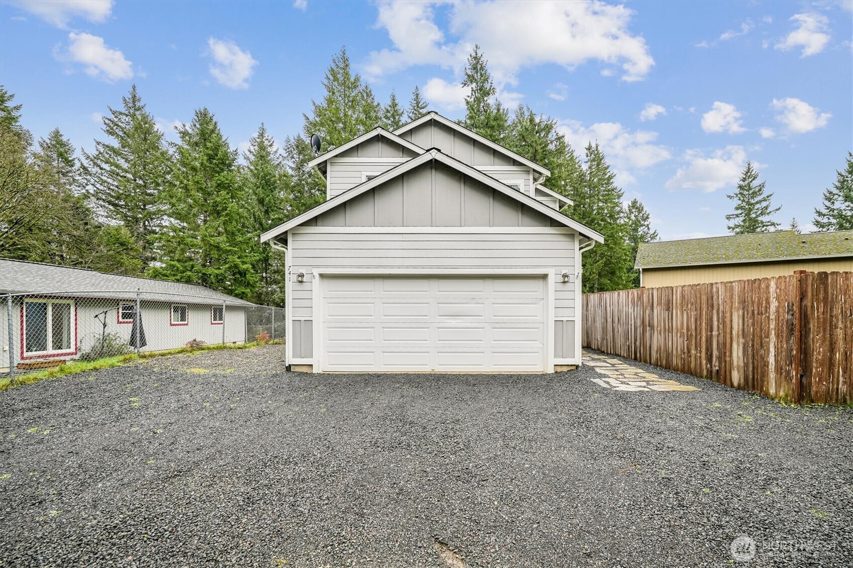 741 Northeast Larson Boulevard Belfair, WA 98528 - Photo 32 of 32 a view of a house with a yard and garage