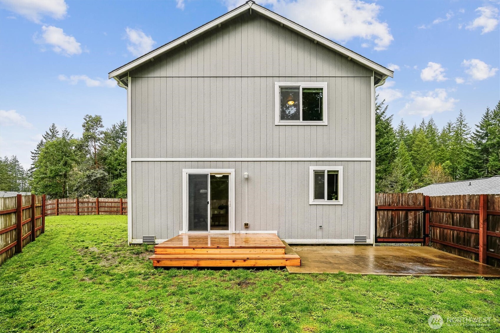 741 Northeast Larson Boulevard Belfair, WA 98528 - Photo 4 of 32 a view of a house with backyard and trees