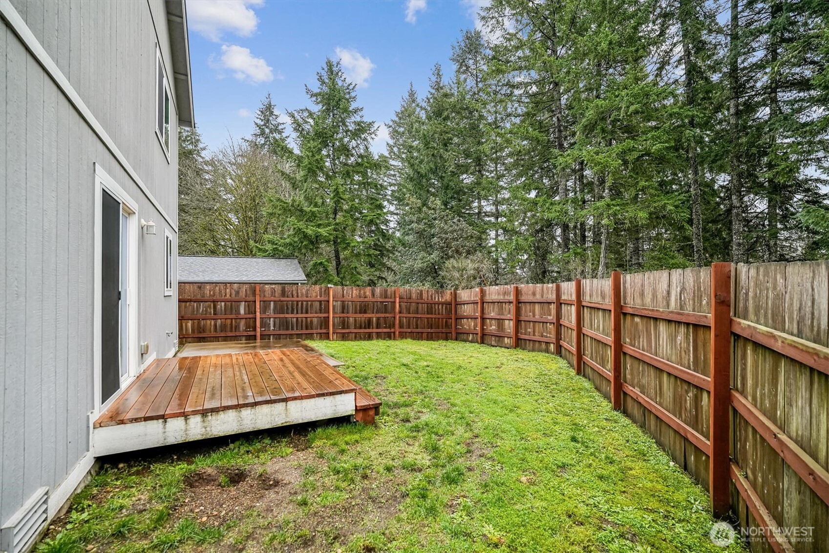 741 Northeast Larson Boulevard Belfair, WA 98528 - Photo 6 of 32 a view of a backyard with a small cabin