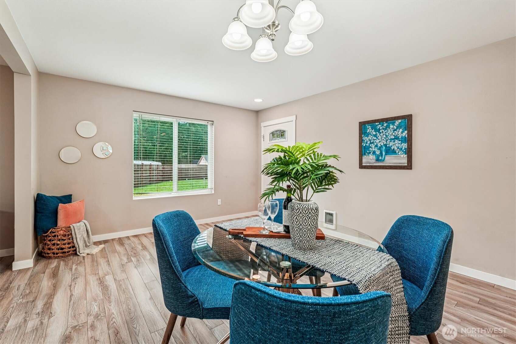 741 Northeast Larson Boulevard Belfair, WA 98528 - Photo 9 of 32 a dining room with furniture potted plants and wooden floor