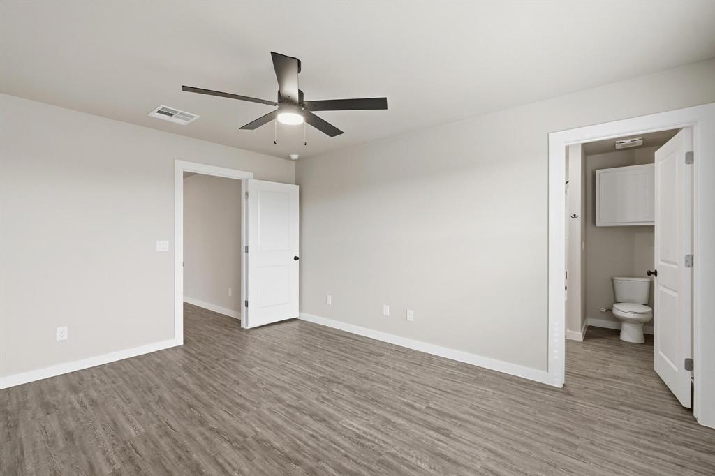 4209 Ranger Road Abilene, TX 79601 - Photo 6 of 10 Unfurnished bedroom with ceiling fan, dark wood-style floors, and ensuite bath