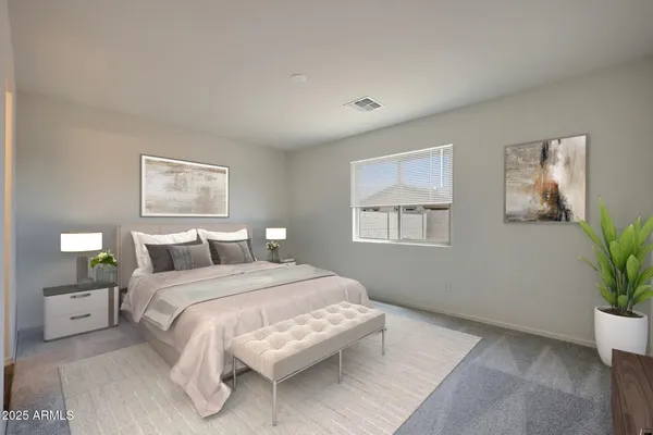 a bedroom with a large bed and a potted plant