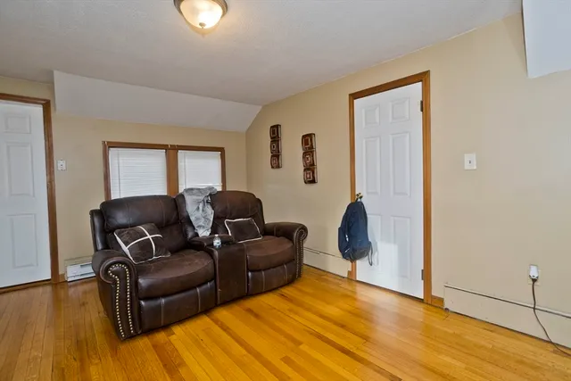 a living room with furniture rug and a window