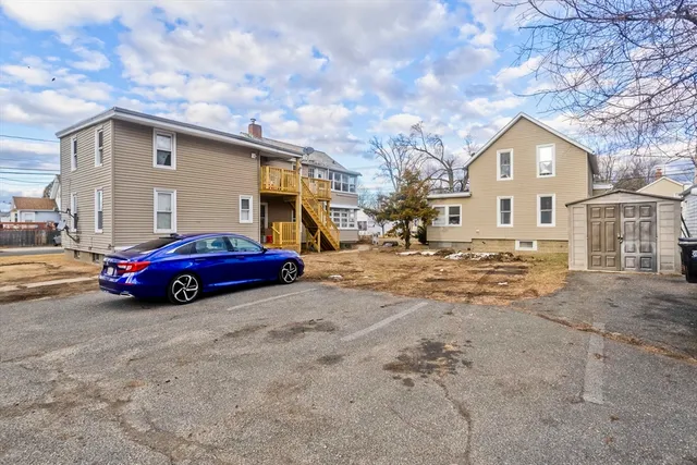 a view of a house with a car parked in front of it
