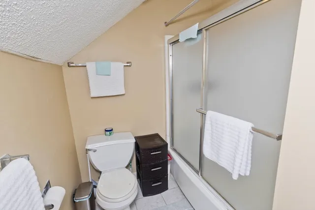 a white toilet sitting next to a bathroom sink and vanity