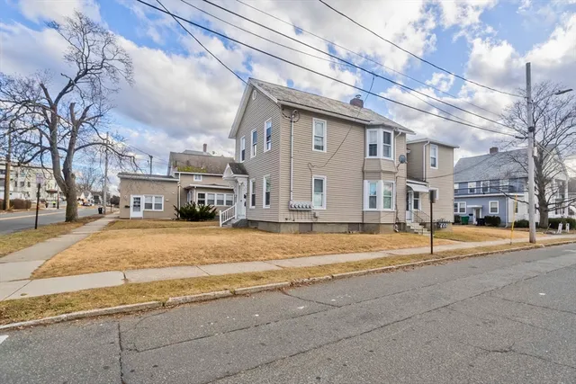 a view of a house with a car parked in front of it
