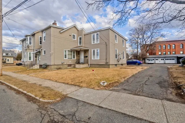 a view of parking with cars parked in front of it