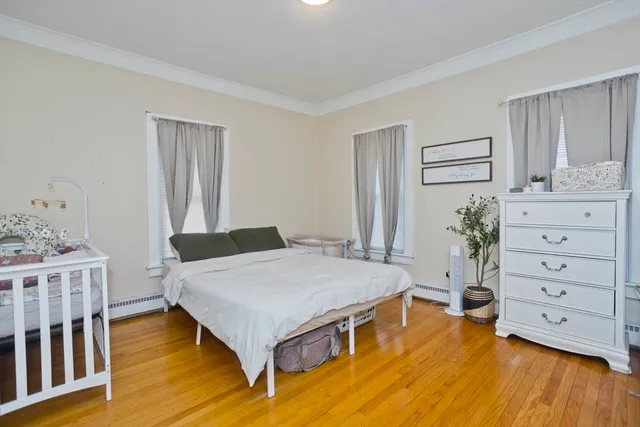 a spacious bedroom with a bed and a dresser