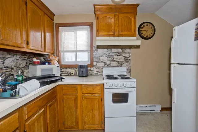 a kitchen with a stove a sink and a refrigerator
