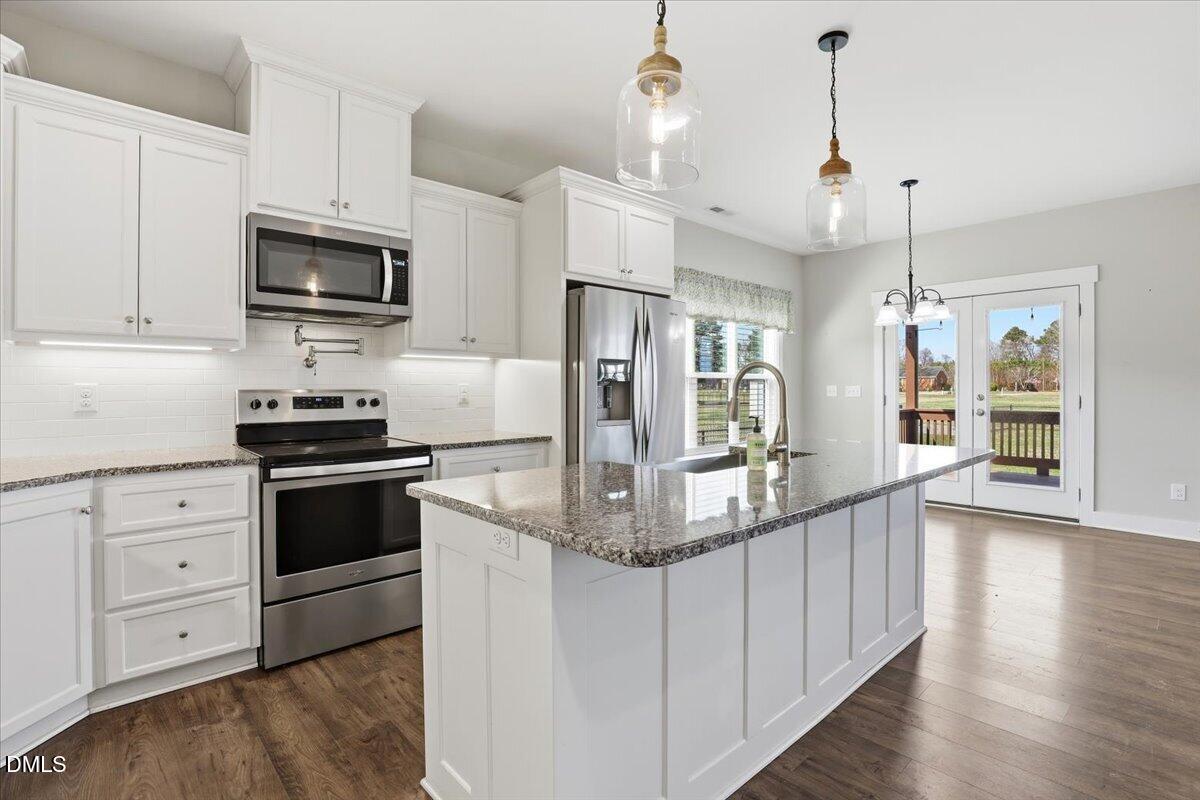 2249 Brogden Road Smithfield, NC 27577 - Photo 11 of 30 a kitchen with stainless steel appliances granite countertop a stove and a refrigerator
