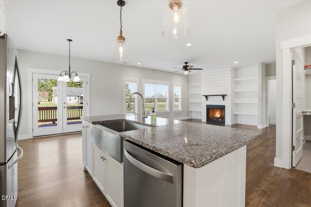 2249 Brogden Road Smithfield, NC 27577 - Photo 12 of 30 a kitchen with kitchen island granite countertop a oven a counter space and wooden floor