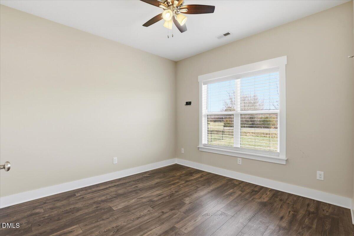 2249 Brogden Road Smithfield, NC 27577 - Photo 23 of 30 a view of an empty room with wooden floor and a window
