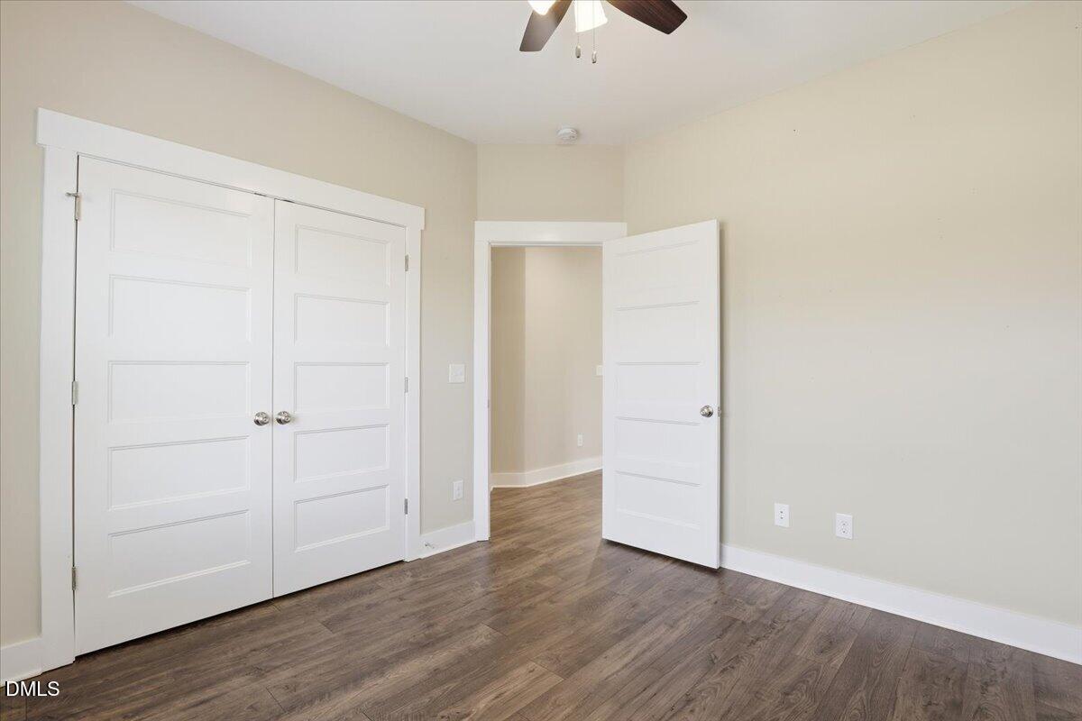 2249 Brogden Road Smithfield, NC 27577 - Photo 24 of 30 an empty room with wooden floor closet and windows