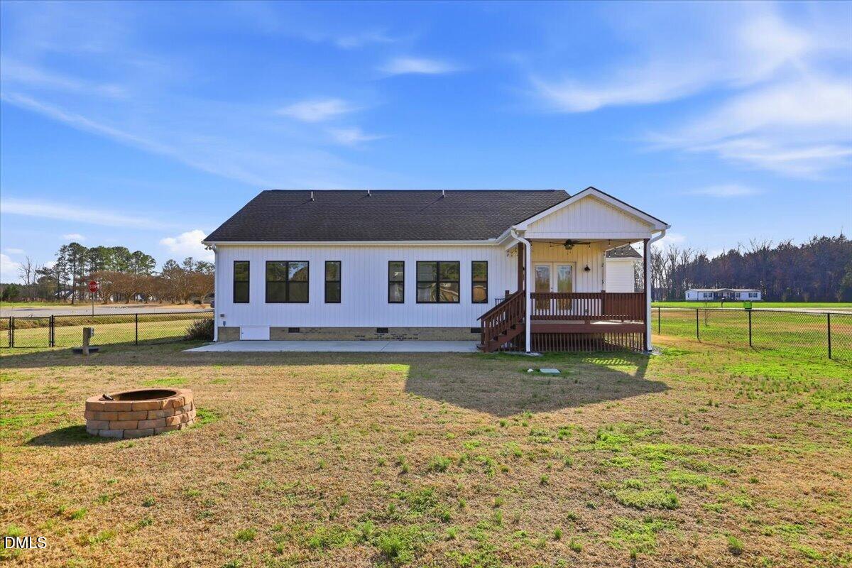 2249 Brogden Road Smithfield, NC 27577 - Photo 28 of 30 a backyard of a house with barbeque oven table and chairs