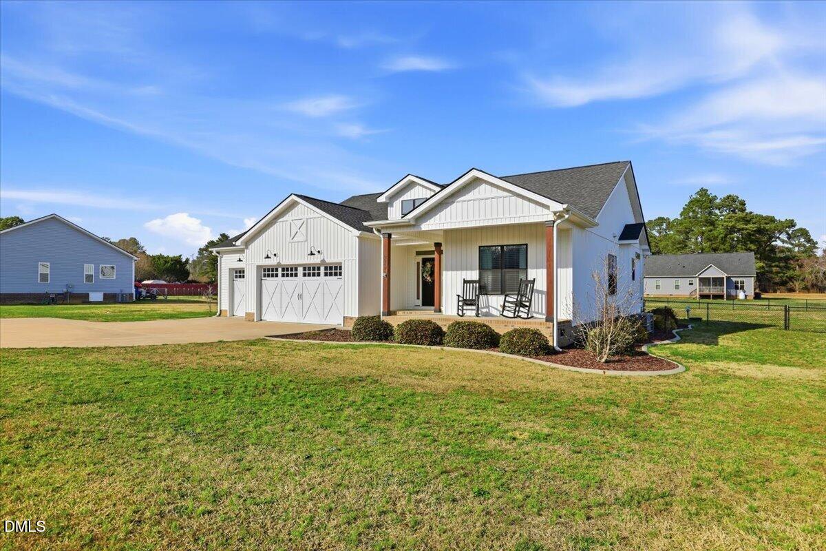 2249 Brogden Road Smithfield, NC 27577 - Photo 3 of 30 a view of a house with a big yard and large trees