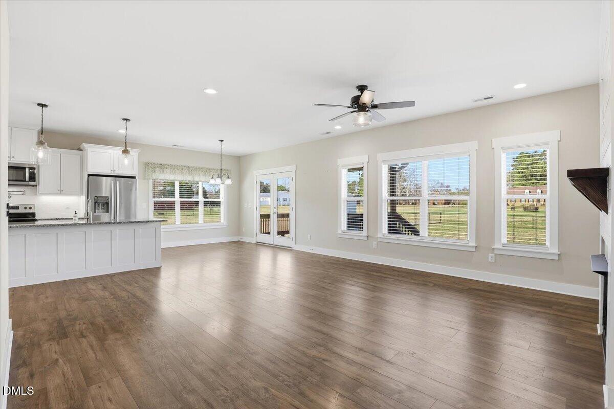 2249 Brogden Road Smithfield, NC 27577 - Photo 5 of 30 an empty room with wooden floor and windows