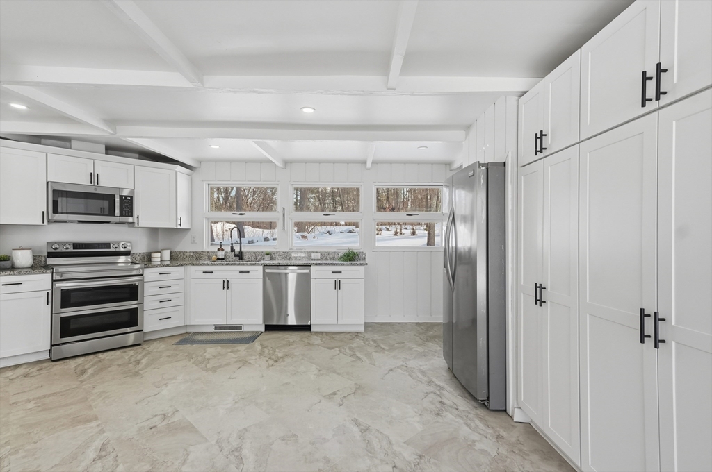 1081 Lowell Road Groton, MA 01450 - Photo 13 of 42 a kitchen with stainless steel appliances a refrigerator sink and stove