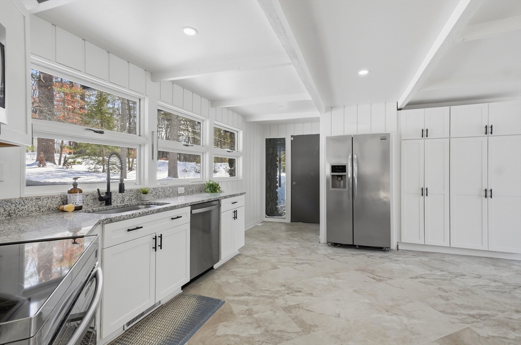 1081 Lowell Road Groton, MA 01450 - Photo 15 of 42 a kitchen with stainless steel appliances granite countertop a refrigerator and a sink
