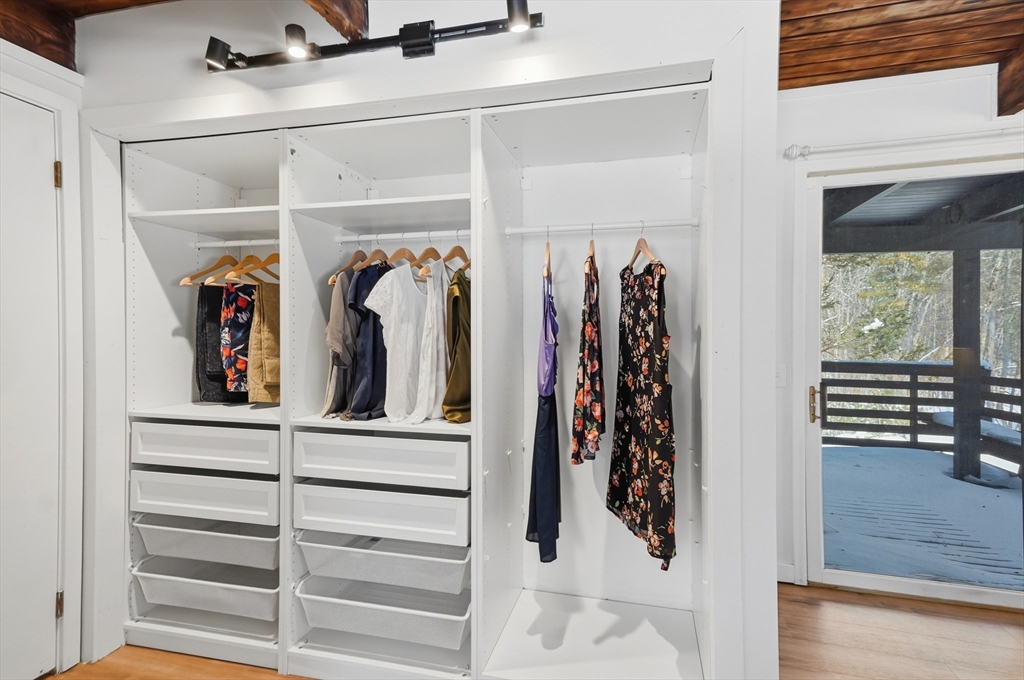 1081 Lowell Road Groton, MA 01450 - Photo 19 of 42 a view of walk in closet with clothes and shoes