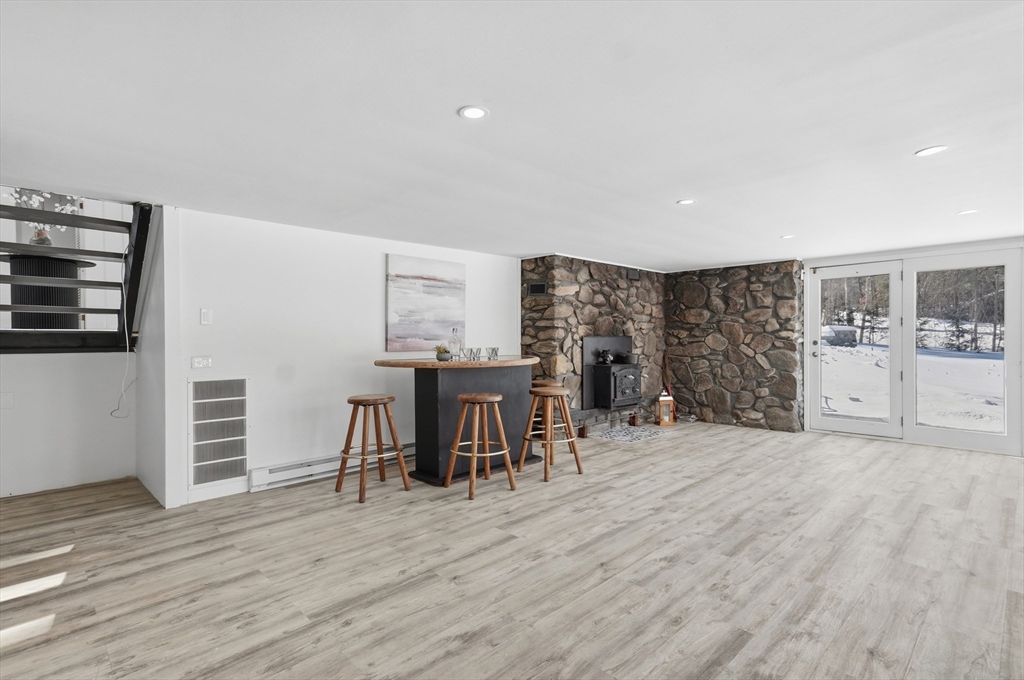 1081 Lowell Road Groton, MA 01450 - Photo 23 of 42 a view of a kitchen with furniture and wooden floor