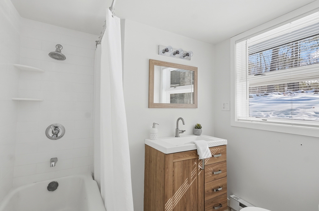 1081 Lowell Road Groton, MA 01450 - Photo 27 of 42 a bathroom with a sink a mirror and a shower